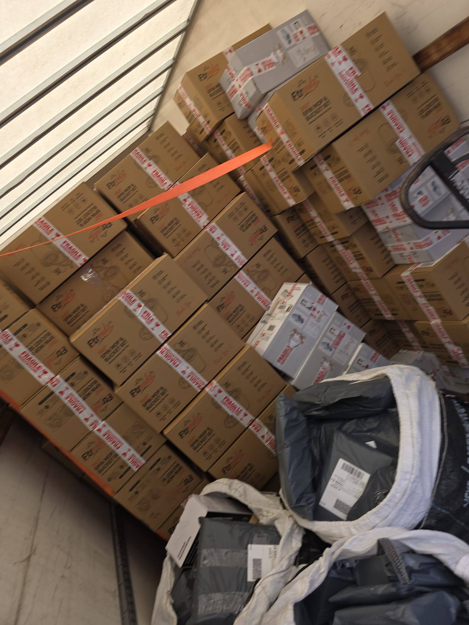 Boxed stock stacked and strapped in the van