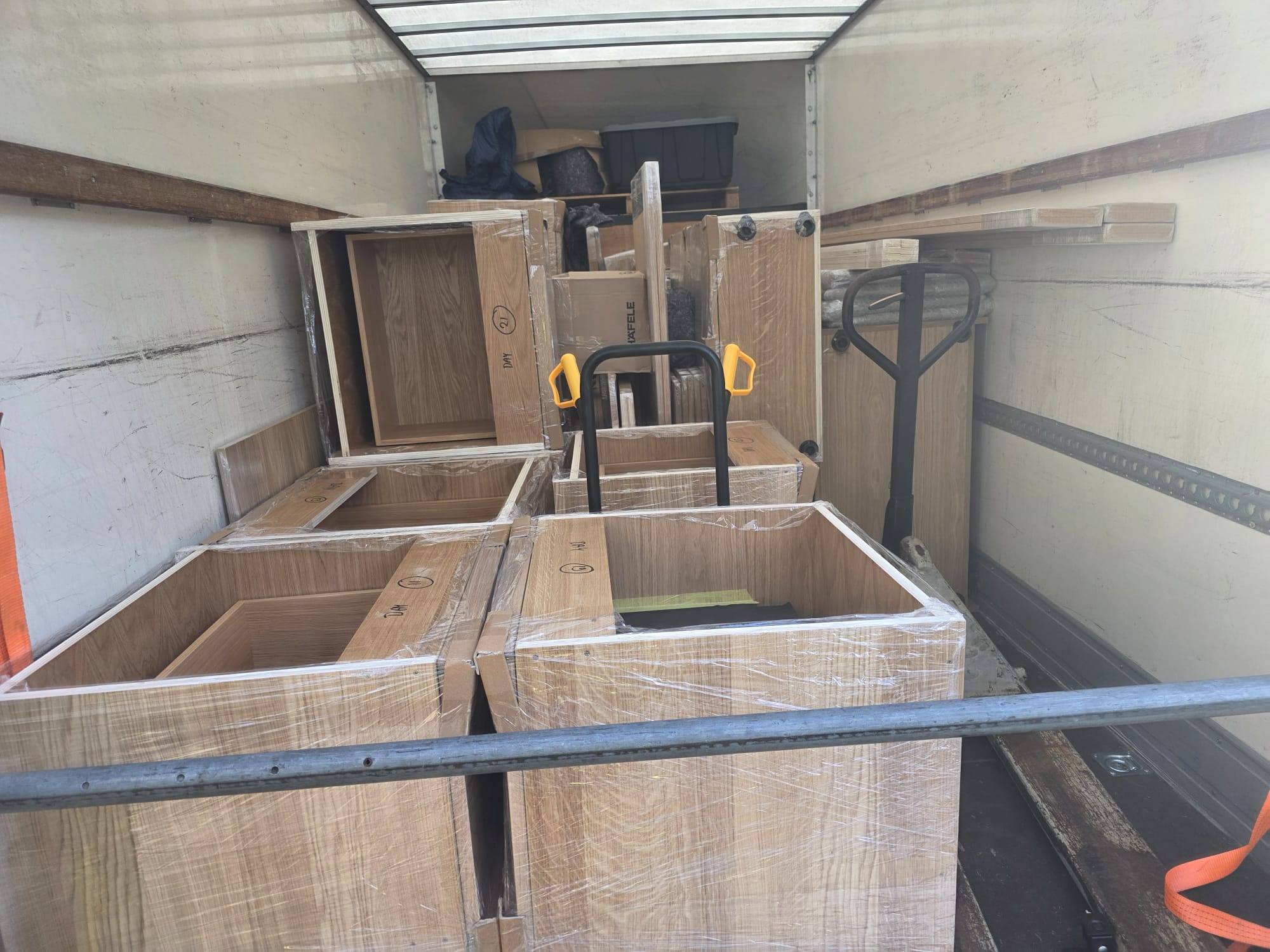Wrapped cabinets loaded neatly in the back of the Luton van