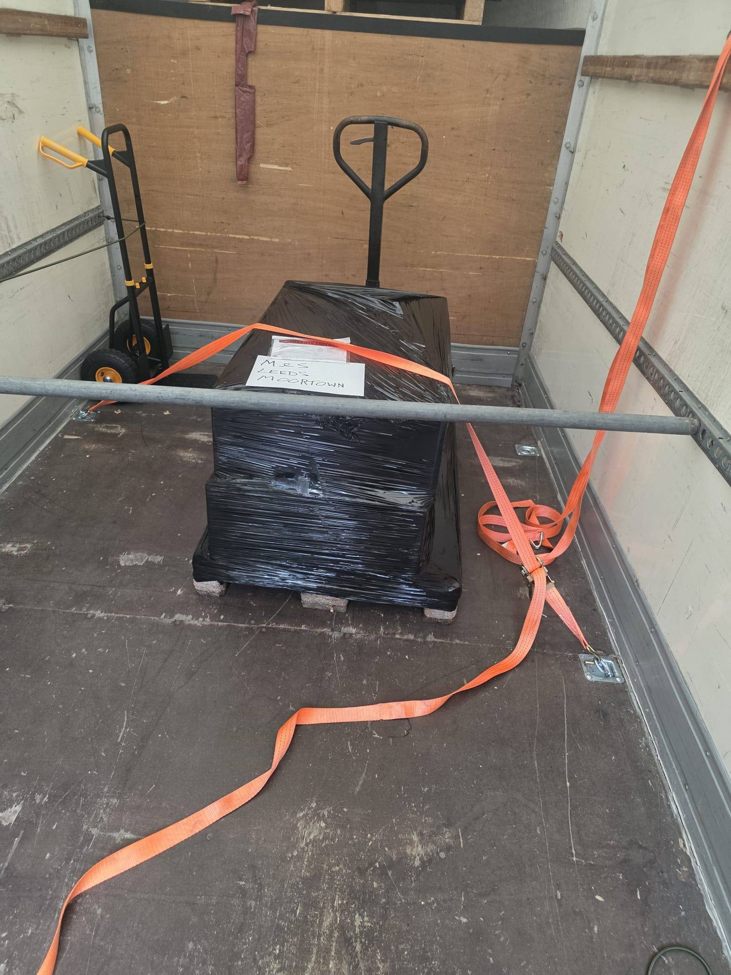 A single wrapped pallet strapped down in the centre of the van floor